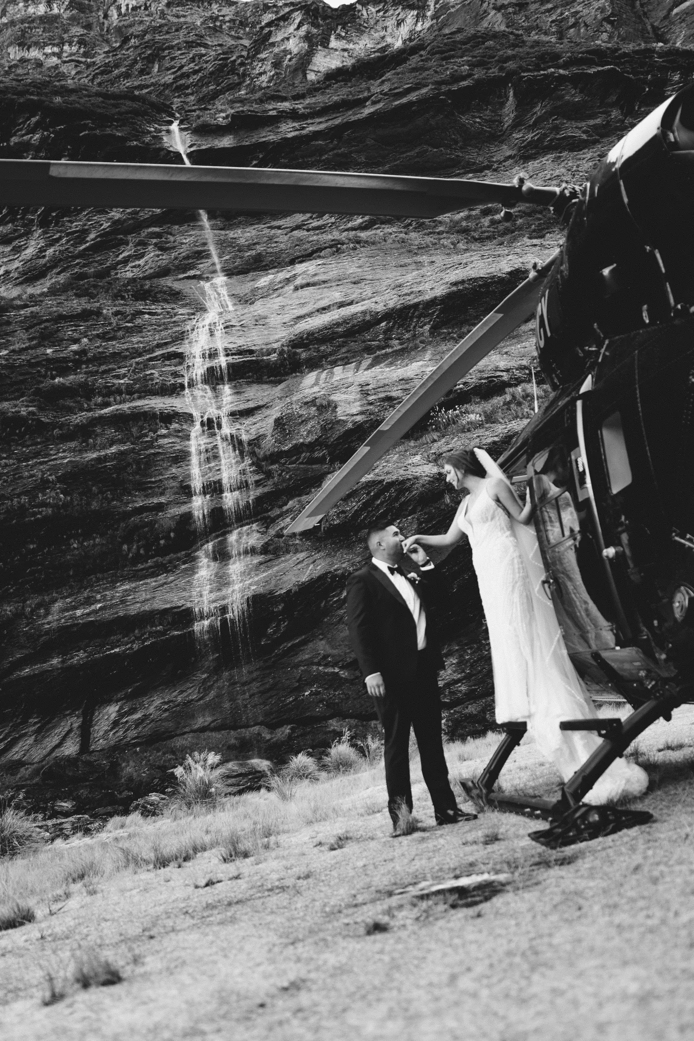 Bride and groom under a veil in the mountains