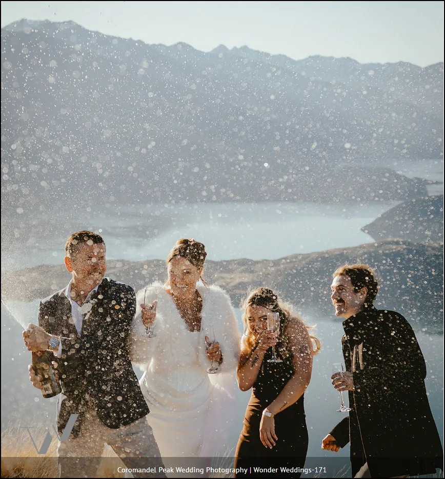 Couple walking through snow, bride in a red gown