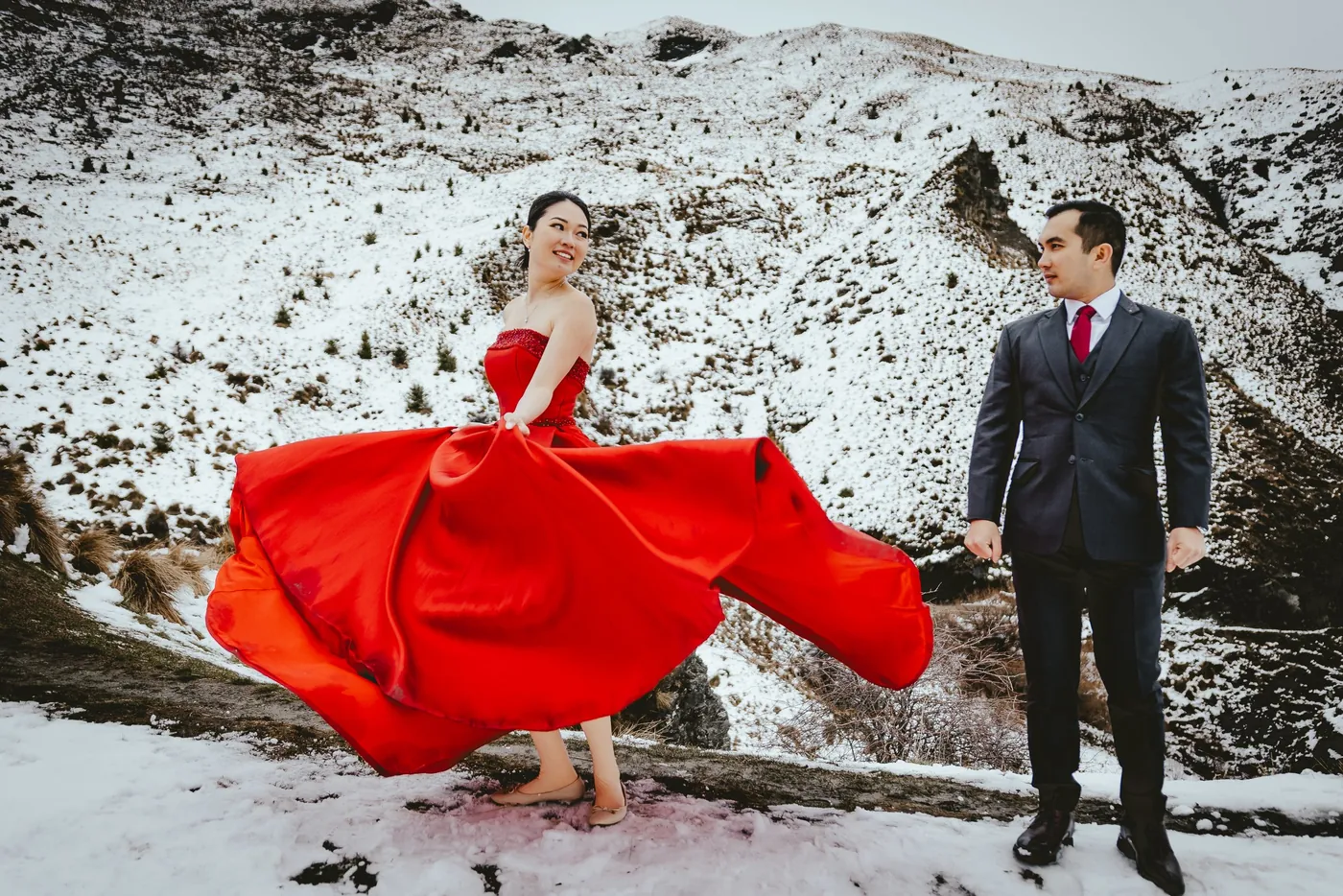 Helicopter landed on a ridge with the wedding couple nearby